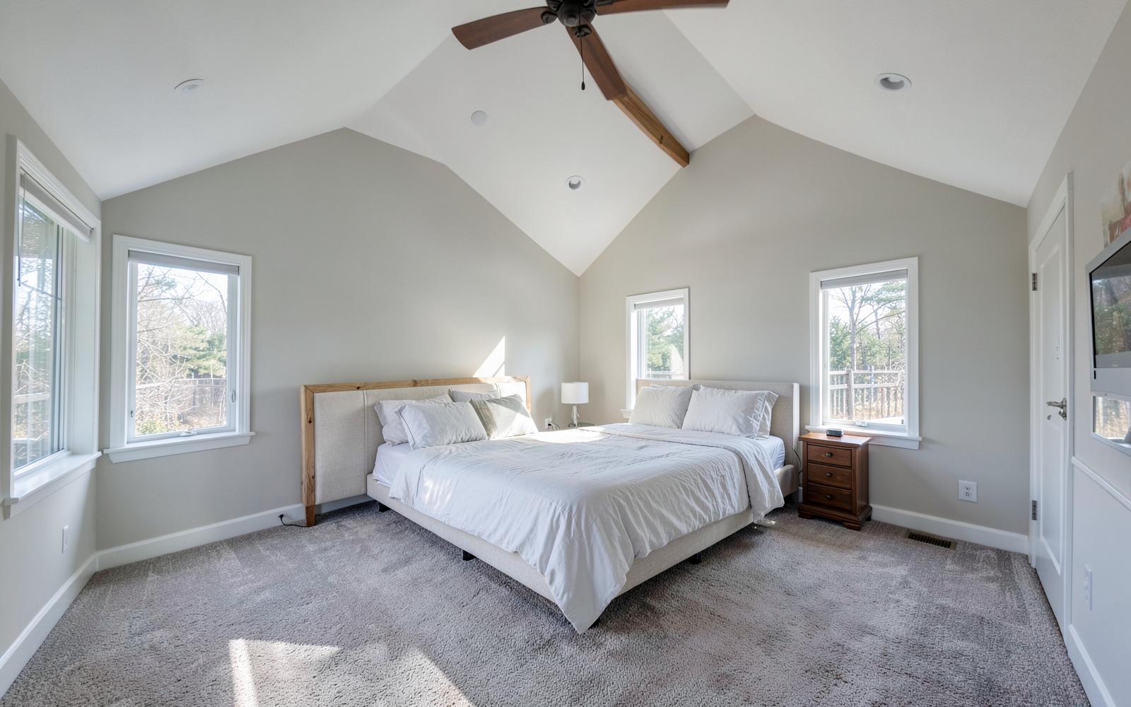 Finished upstairs master bedroom with vaulted ceiling in a second story addition