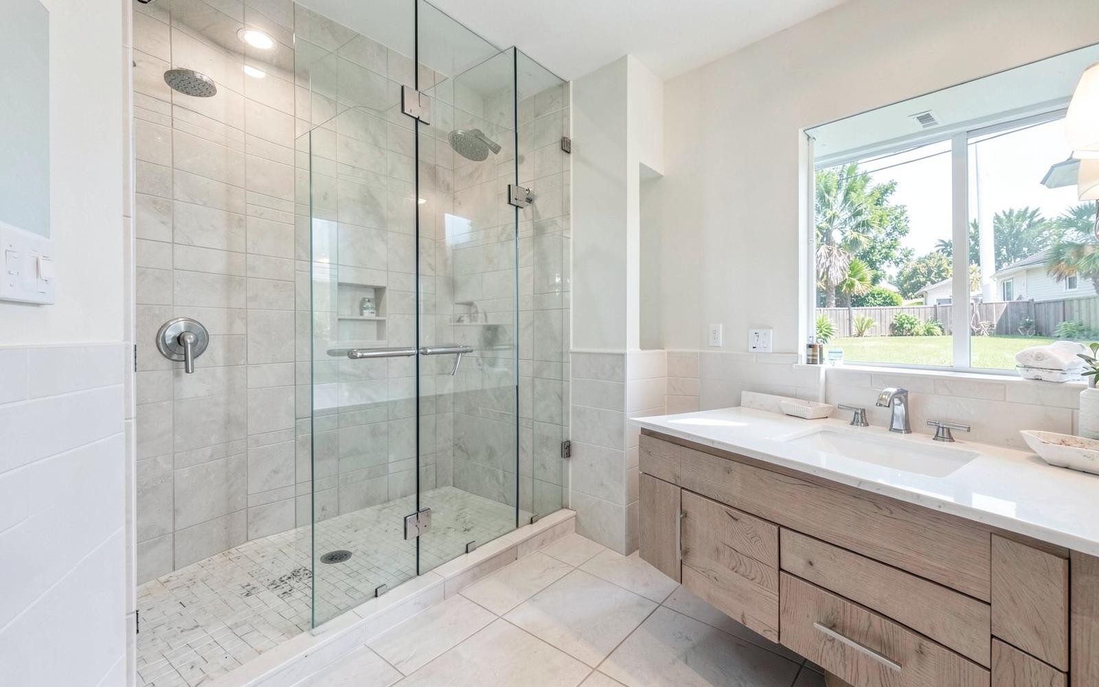 Renovated bathroom with tiled walk-in shower and floating vanity