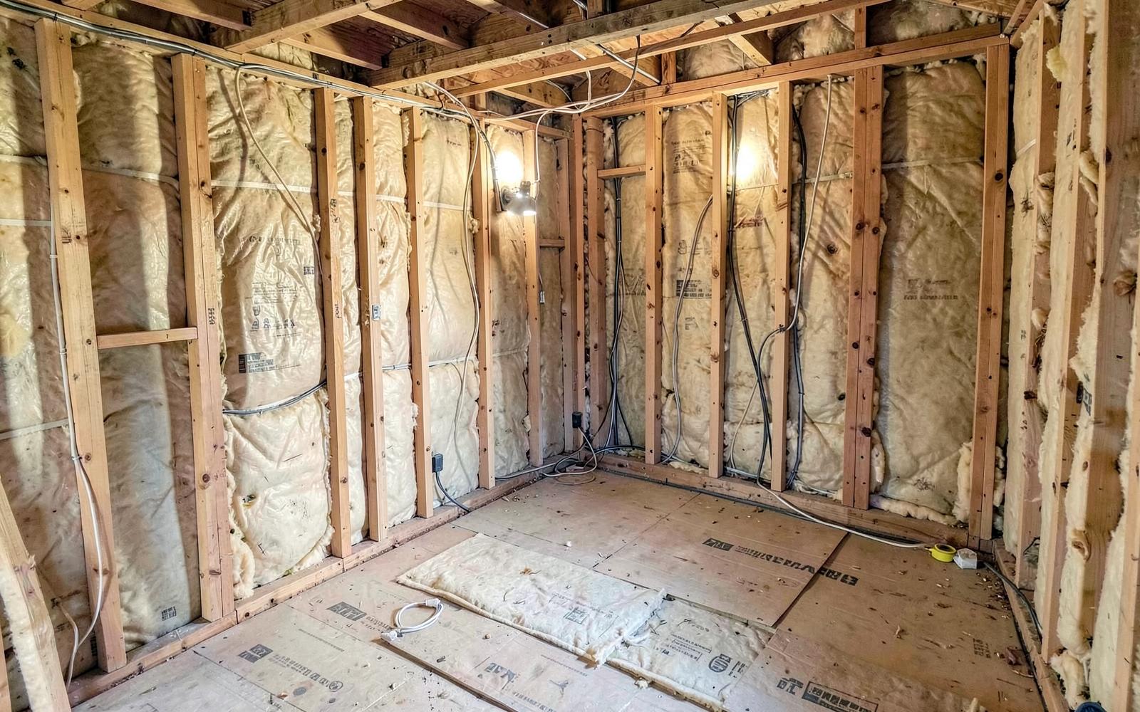 House extension interior mid-build with new wiring and insulation between studs
