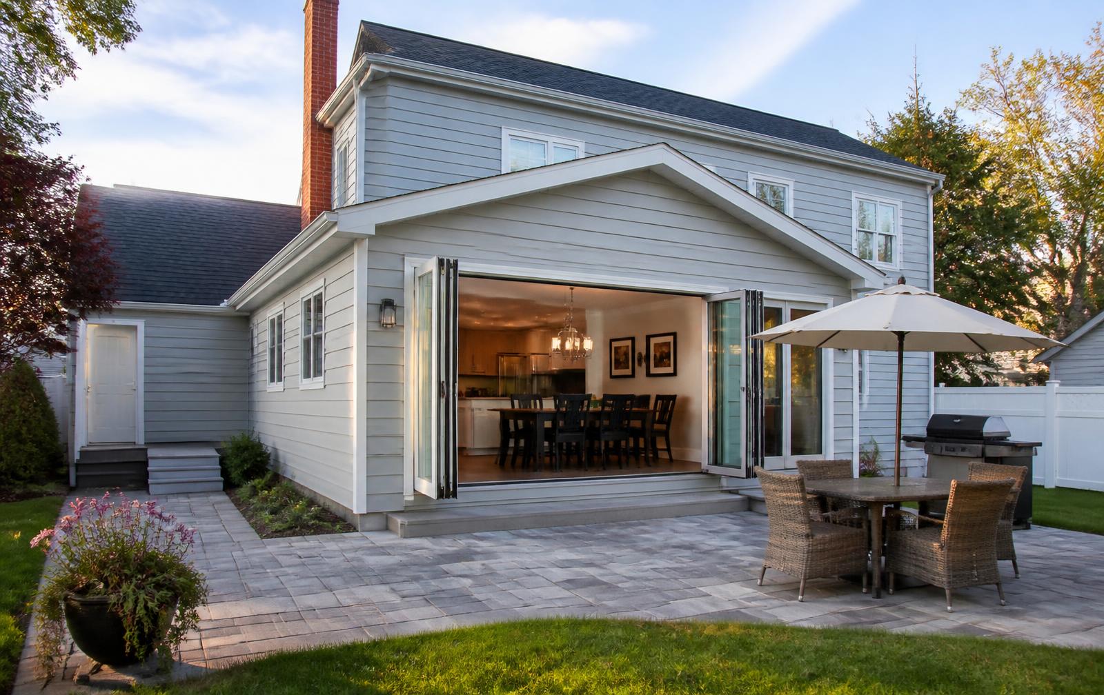 Rear house extension with folding glass doors opening onto a patio in New Jersey