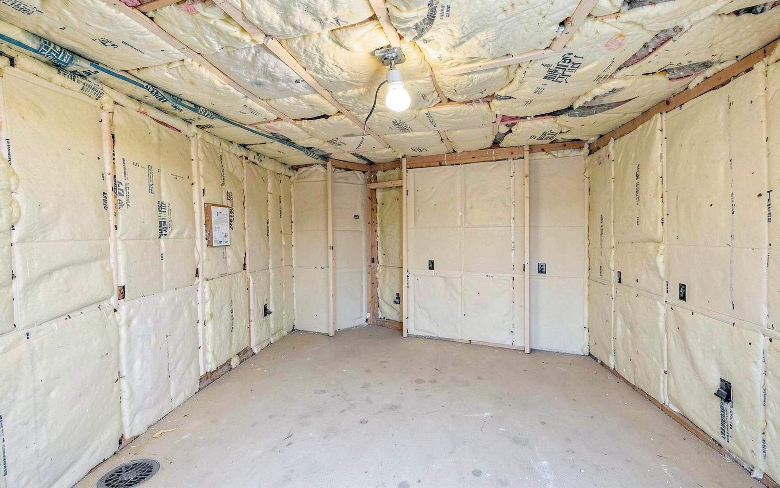 Insulation installed in the walls and ceiling of a new over-garage room