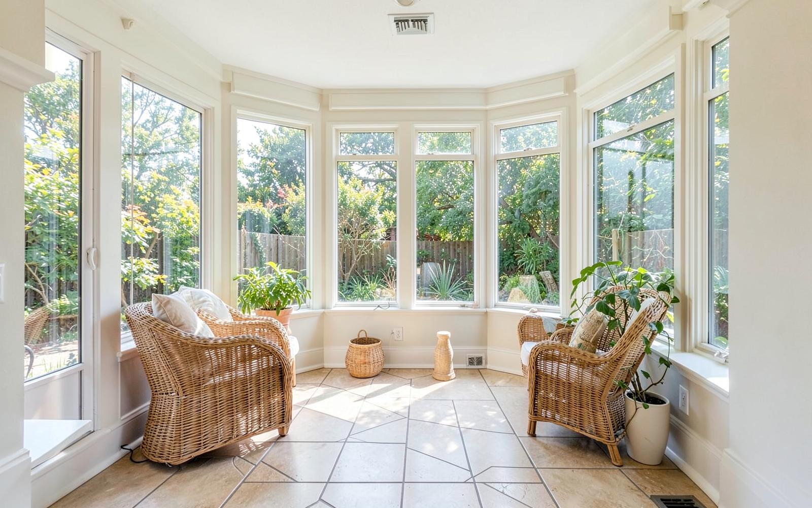 Bright sunroom addition with a wall of windows and tile floor
