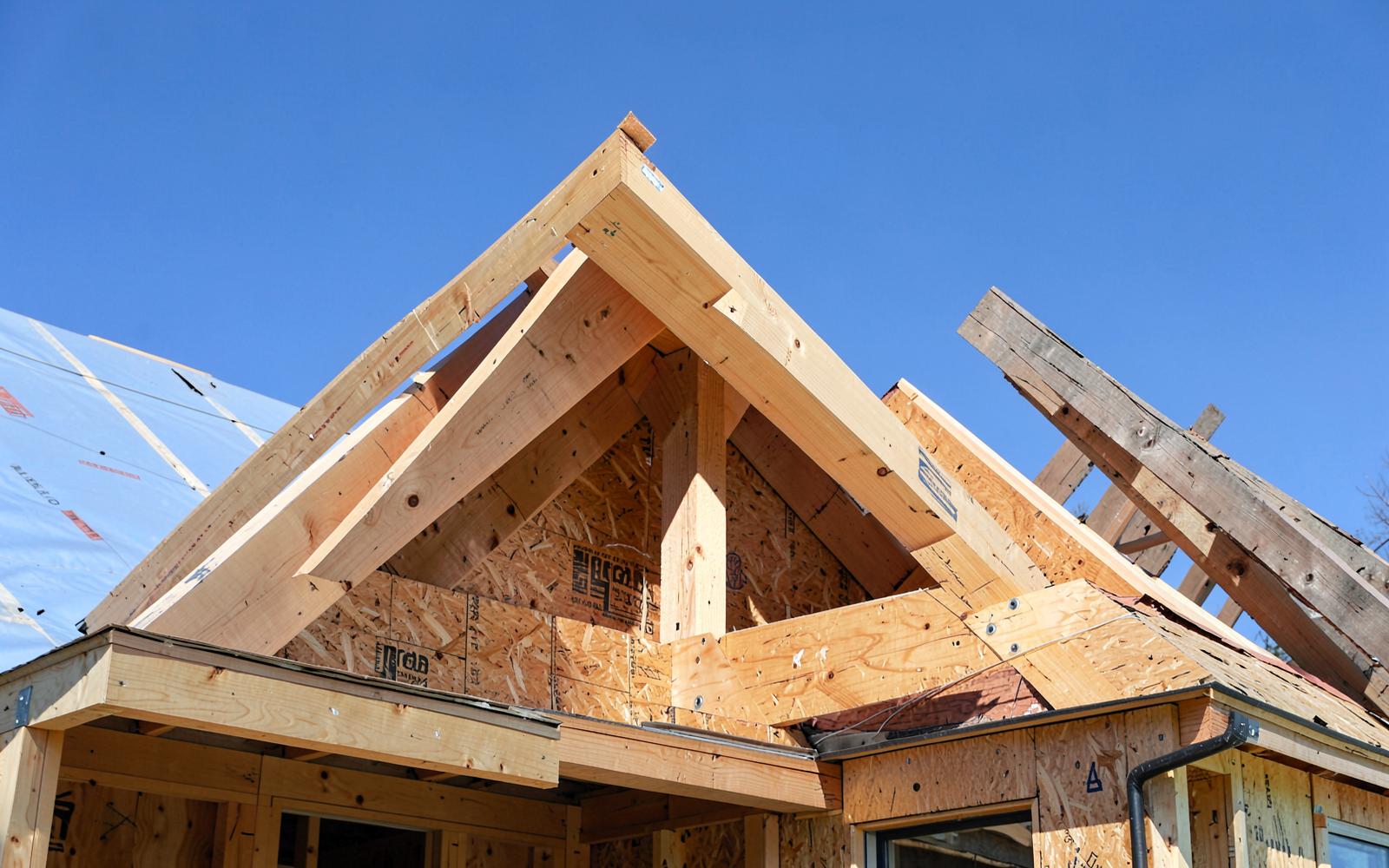 New roof rafters and ridge beam tied into an existing roof
