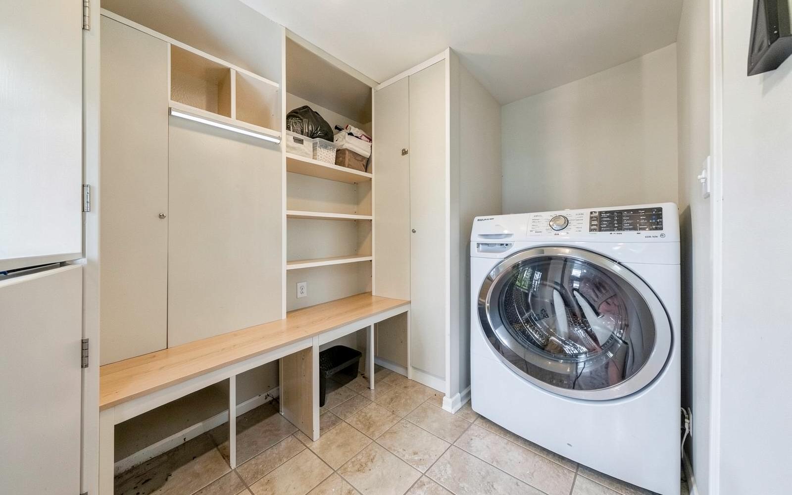 New mudroom and laundry area with built-in bench and cubbies